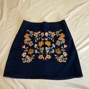 Francesca’s Navy skirt with floral appliqué